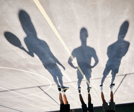 Basketball, shoes and silhouette of team upside down on basketball court training for game or competition. Fitness, sports and shadow of basketball players ready for exercise, workout or practice.の写真素材