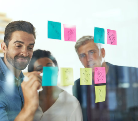 Brilliant brainstorming in action. a group of colleagues having a brainstorming session in a modern...