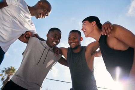 Happy, team building and fitness men on a basketball court planning a strategy, mission and goals in a training game. Sports, mindset and healthy athletes laughing, talking or speaking of a missionの写真素材