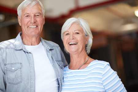 Cropped portrait of happy senior couple standing side by side.
