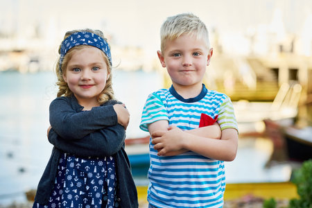Whos the cutest. Portrait of a cute little brother and sister posing together on a day out.の写真素材