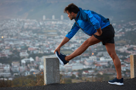 Getting ready to conquer the city. a young athletes exercising outdoors.の写真素材
