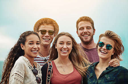 Best friends make the best memories. Portrait of a group of friends spending time together outdoors.の写真素材