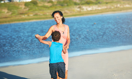 My mother is my first love. a mother and son dancing on the beach.の写真素材