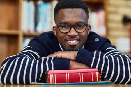 My sights are set on a brighter future. Portrait of a university student sitting in the library at...