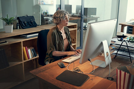 The common characteristic of successful people is hard work. a mature businesswomen working on a...