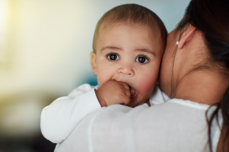 I got my mommas back. a loving mother carrying her baby boy at home.の写真素材