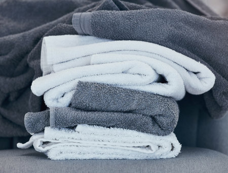 Towels, clean and laundry with texture and fabric for cleaning and hygiene in hospitality or home. Fresh washing, cleaning service or household maintenance closeup with cotton towel and textures.の写真素材