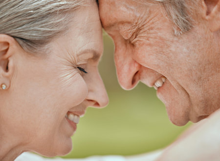 Love, senior couple and touch face of a marriage with elderly people feeling care and happiness....
