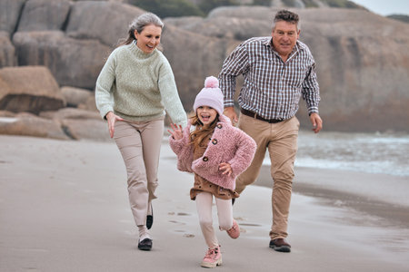 Beach, running and family grandparents with child holding hands for outdoor wellness, energy and...