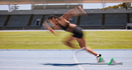 Fitness, run and fast blur athlete running on a race track for sports, athletics and exercise on the track. Workout, training and cardio jogging with sportswoman racing or sprinting outsideの写真素材