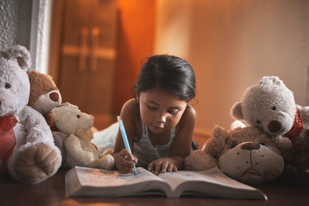 Every childs life should be a colourful one. an adorable little girl colouring in a picture at home.