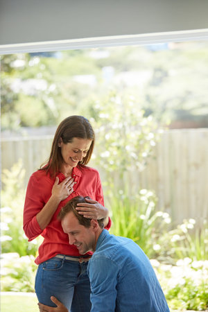 Becoming parents is the greatest news theyve always wanted. a man pressing his ear to his wifes...