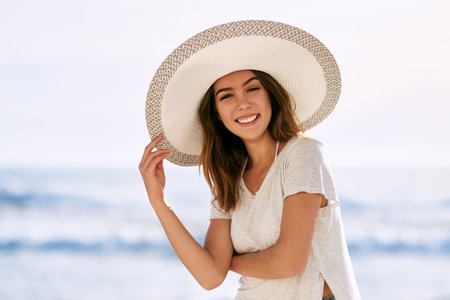 Salty but sweet. a beautiful young woman posing on the beach.の写真素材