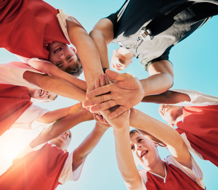 Hands, collaboration and children with a team in sports together standing in a huddle or circle from...