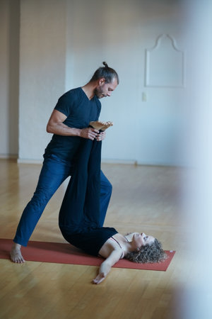 Just a little further. a young physical therapist working with his female patient.の写真素材