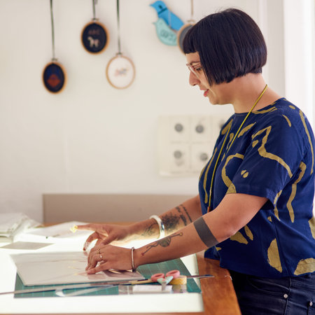 Let her creativity thrive. a stylish young designer at working at a table in her studio.