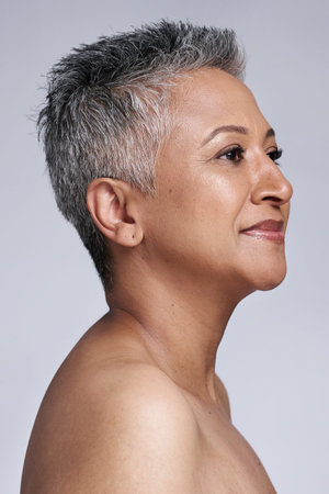 Beauty, woman and skincare, face and antiaging with healthy skin motivation and facial treatment against studio background. Natural cosmetics advertising with mature model, grooming and fresh glow.の写真素材