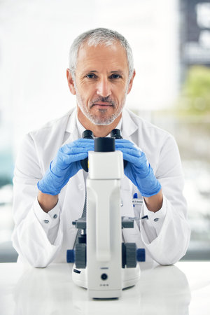 Im get to the cause of this disease. a scientific researcher at work on a microscope in a lab.