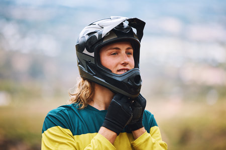 Motor cross, motorcycle sports and man biker ready for a bicycle race or training outdoor in nature. Motorbike helmet, guy and adventure sport person outdoors for fitness, workout and cyclingの写真素材