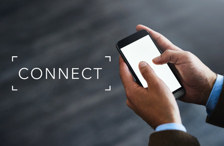 Always connected. High angle shot of an unrecognizable businessman using a mobile phone alongside the word connect.の写真素材