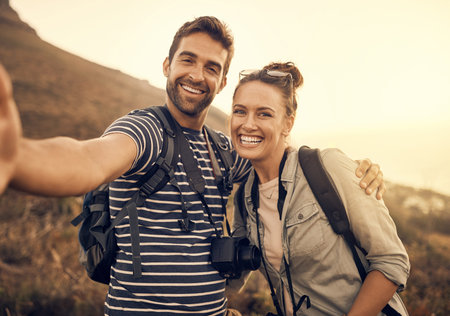 I want to share this moment with everyone. a happy couple taking a selfie while out on a hiking...
