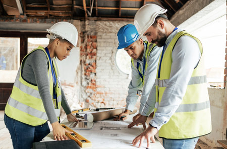 Architect, construction and teamwork with an engineer, designer and technician working together on a...