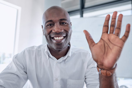 Business video call, wave and black man in office, video conference or meeting. Portrait, hello or...