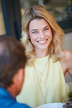 Brunch with my favourite person. Portrait of a happy young woman enjoying a meal with her husband at home.の写真素材