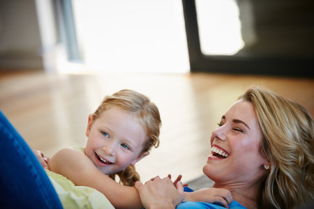 The best days of a mothers life. a young mother playing with her daughter in their home.の写真素材