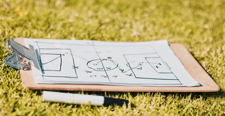 Clipboard, paper and soccer strategy, planning with tactics for team game plan and formation on a grass sport field. Document, pen and icon drawing, sketch and football plan for match on sports pitchの写真素材