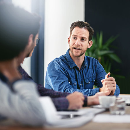 Pitching them an idea. a group of businesspeople meeting in the boardroom.