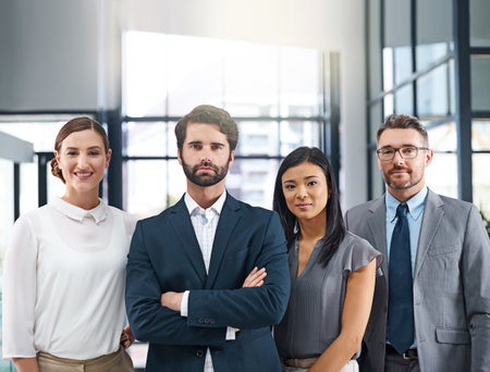 Were the team you need. Cropped portrait of a group of businesspeople standing in the office.の写真素材