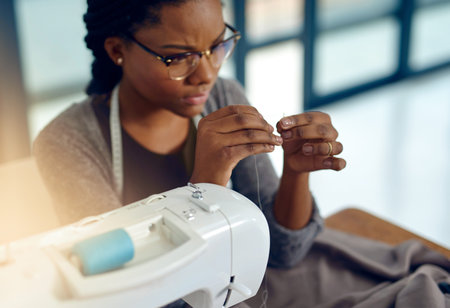 Keep calm and sew on. a young designer doing some needle work.