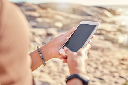 Hands, phone and mockup space in nature for marketing or advertising. Mock up, tech and woman networking on 5g mobile, texting online or social media, scrolling on smartphone or internet browsing.の写真素材