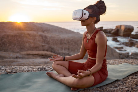 Woman, metaverse or vr headset in yoga meditation by beach, ocean waves, sea water in mental health support, zen app or 3d peace ai. Lotus, relax or wellness person on virtual reality chakra softwareの写真素材