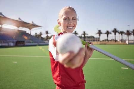Sport, hockey and woman with fitness on field, athlete in stadium portrait, happy with exercise outdoor. Hockey player, ball and stick on turf ready for game, training and sports motivation.の写真素材