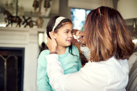 Youre never fully clean until youre mom clean. a caring mother wiping her daughters face at home.の写真素材