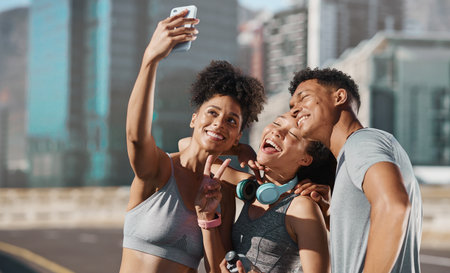 Fitness, city friends and phone selfie, motivation for training with happy runner friend or personal trainer. Urban workout, running club and fun photo with smile on smartphone after healthy exerciseの写真素材