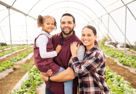 Farming, agriculture and happy family together for sustainability, small business and healthy lifestyle. Happy agro farmer man, woman and child learning ecology on sustainable farm or greenhouseの写真素材