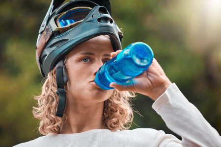 Water bottle, drink and man in mountain bike travel, journey or adventure in nature forest for...