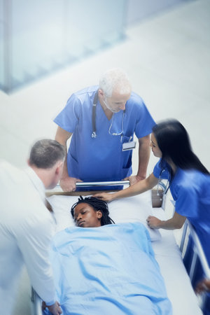She needs immediate medical attention. a group of medical professionals looking at a patient on a...