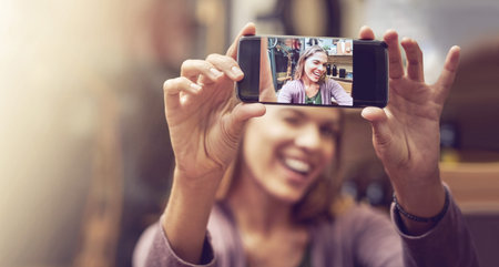 Time to open the store, but firsta selfie. a young woman taking a selfie in a store.