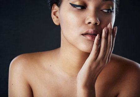 This must be what perfection feels like. a beautiful woman posing against a black background.の写真素材