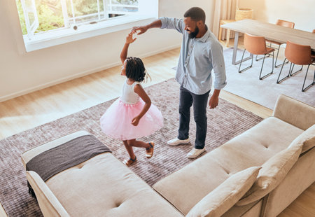 Man, father or girl ballet dancing in living room of house or happy family home in energy, ballerina tutu or dress in top view. Dad, child or dancer kid bonding in creative comic fun in South Africaの写真素材