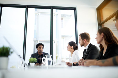 Having their morning meeting. a group of business colleagues meeting in the boardroom.