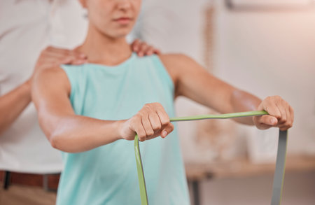 Woman hands, man and physiotherapy resistance band in for strong muscle growth, strength management or mobility. Physiotherapist, sports athlete or personal trainer in band rehabilitation healthcareの写真素材