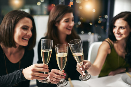 Girls night. a group of young girlfriends toasting during a dinner party at a restaurant.