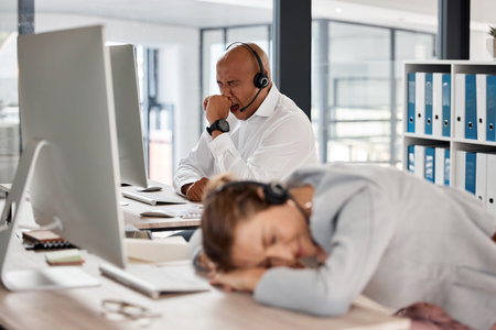 Call center burnout, tired customer service team and consultant exhausted after crm consulting, working or customer support. Telemarketing, online help desk and sleeping agent with overtime fatigueの写真素材