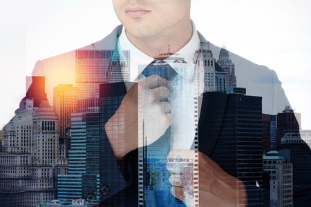Looking sharp and ready to take over the city. Multiple exposure shot of an unrecognisable businessman superimposed over a cityscape.の写真素材